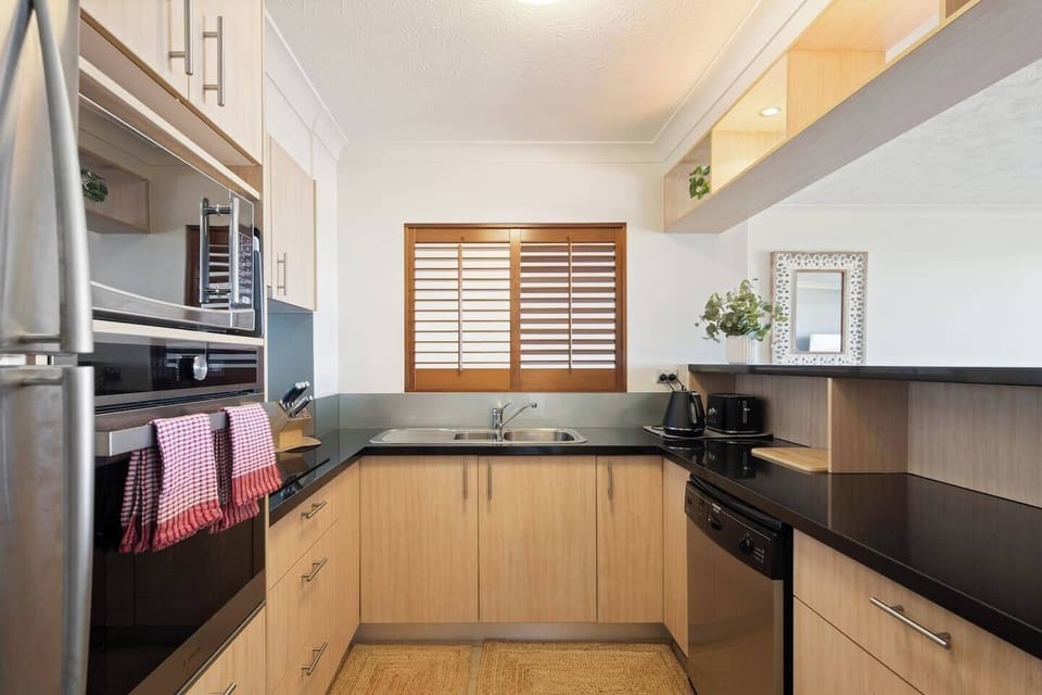 Prepare meals in the fully equipped kitchen, complete with an oven, dishwasher, microwave, and all the cooking essentials you need.