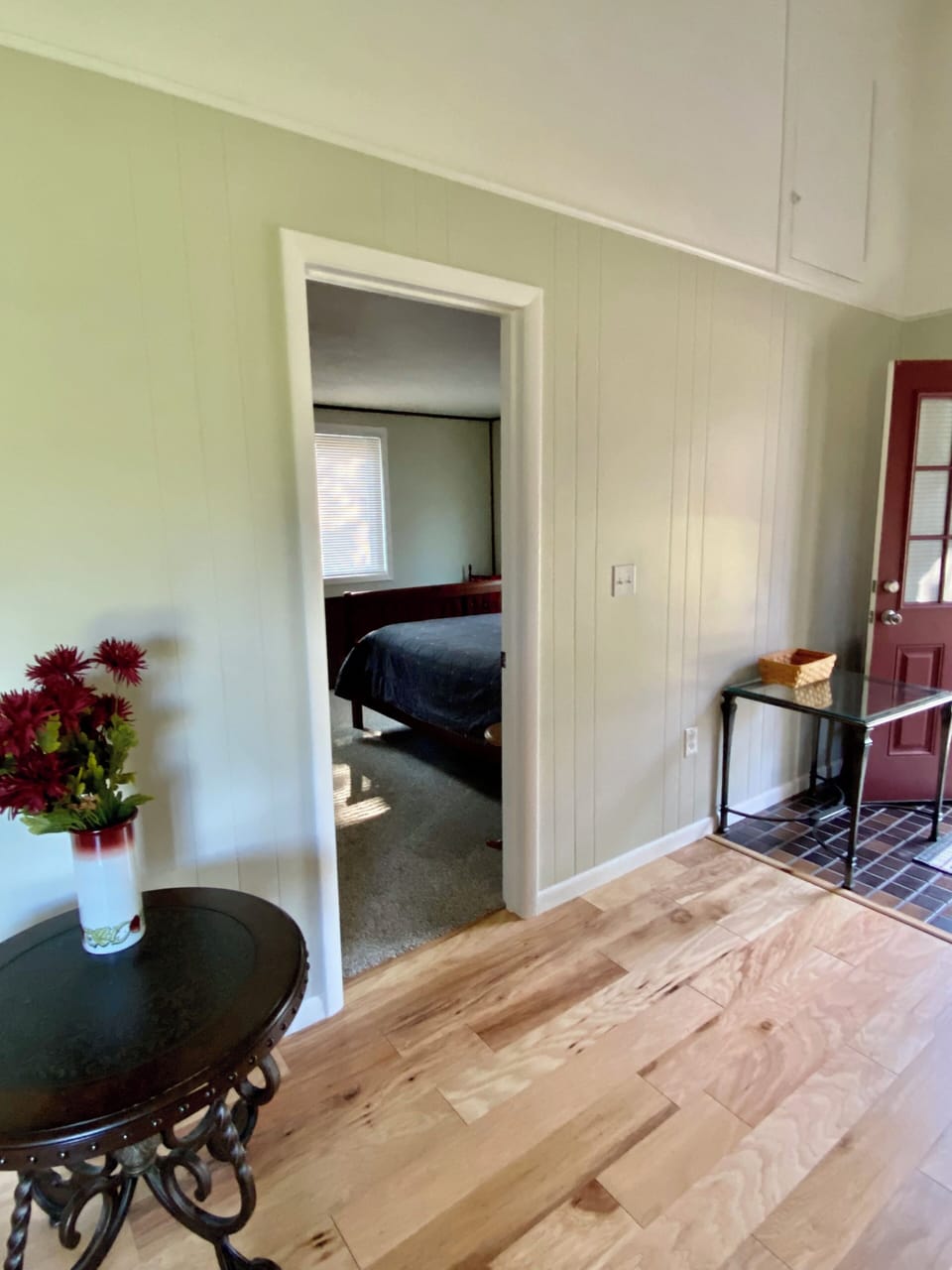 Family room view into queen bedroom with TV