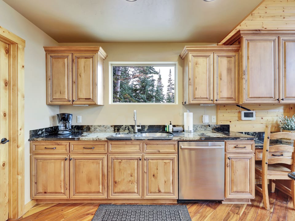 Stainless steel KitchenAid appliances and deep prep sink at Aspen Lodge, Brian Head, Utah. Premium kitchen equipment in a luxury 3,900 sq ft mountain cabin — perfect for cooking for large groups.