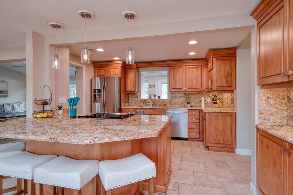 Large stocked kitchen with stainless steel great for cooking and dining.