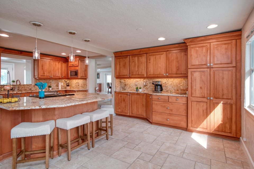 Spacious kitchen with stainless steel appliances ideal for cooking.