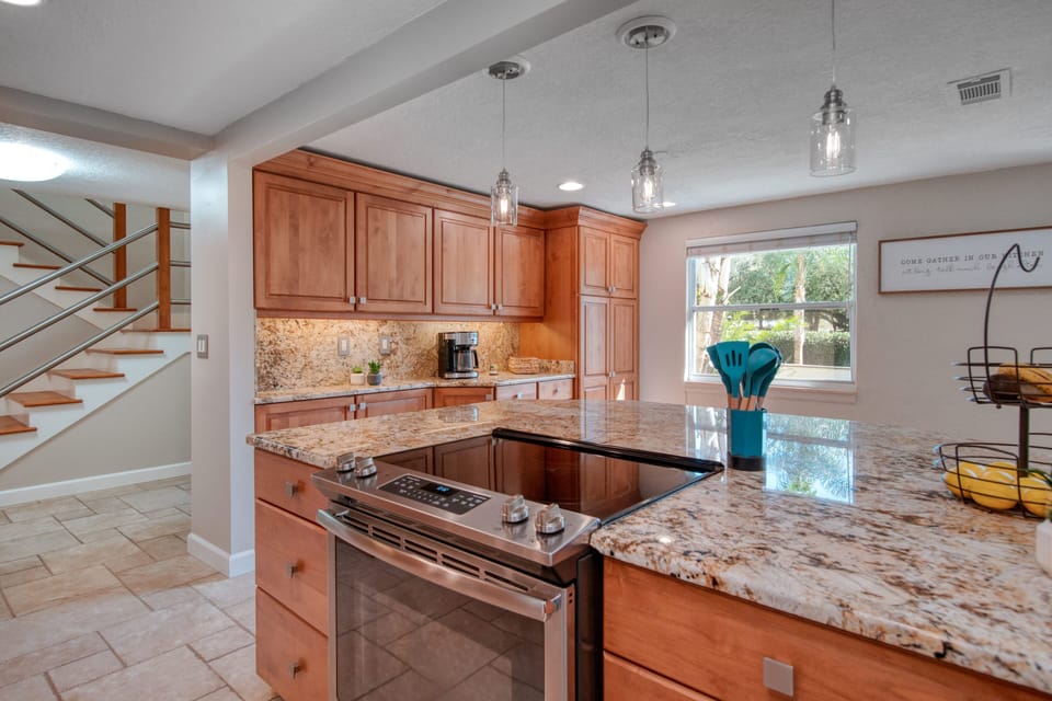 Large stocked kitchen with stainless steel perfect for cooking and meals.