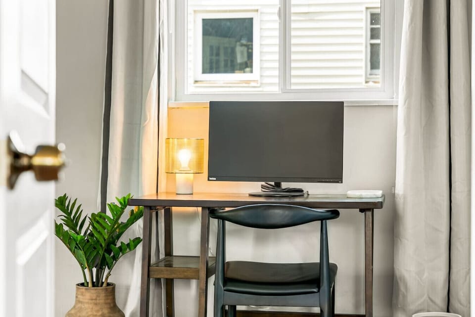 Quiet workspace featuring a monitor, desk, and chair