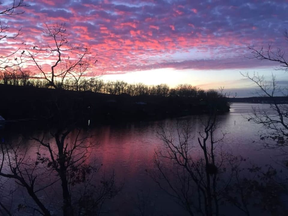 Imagine waking up to stunning lake views and vibrant sunsets, perfectly captured in this picturesque setting. With serene waters right outside your door, this rental offers an idyllic escape for peaceful mornings and breathtaking evenings.