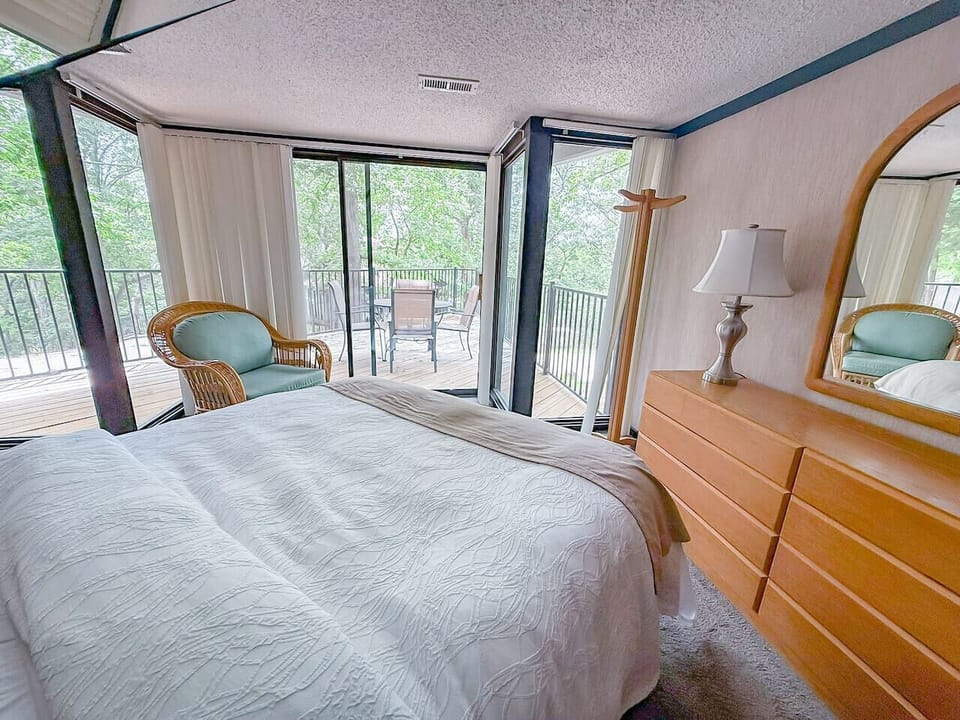 Experience lakeside living from your bedroom! Step onto your private deck and soak in the serene beauty of the Lake of the Ozarks.