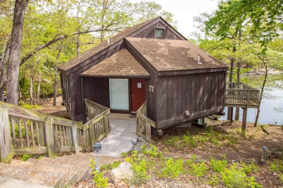 This modern elevated home offers a unique `treetop` living experience, blending seamlessly with the surrounding lush natural landscape. Multiple large windows allow for abundant natural light and scenic views, making this a bright and inviting retrea