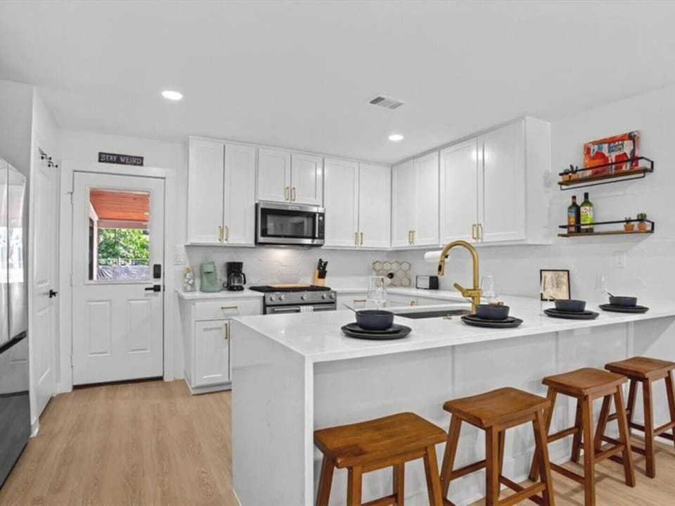 Bright, fully equipped kitchen with modern appliances and spacious island seating