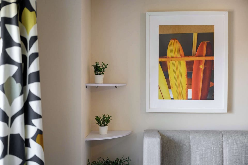 Vibrant artwork and fresh greenery add personality to your bedroom
