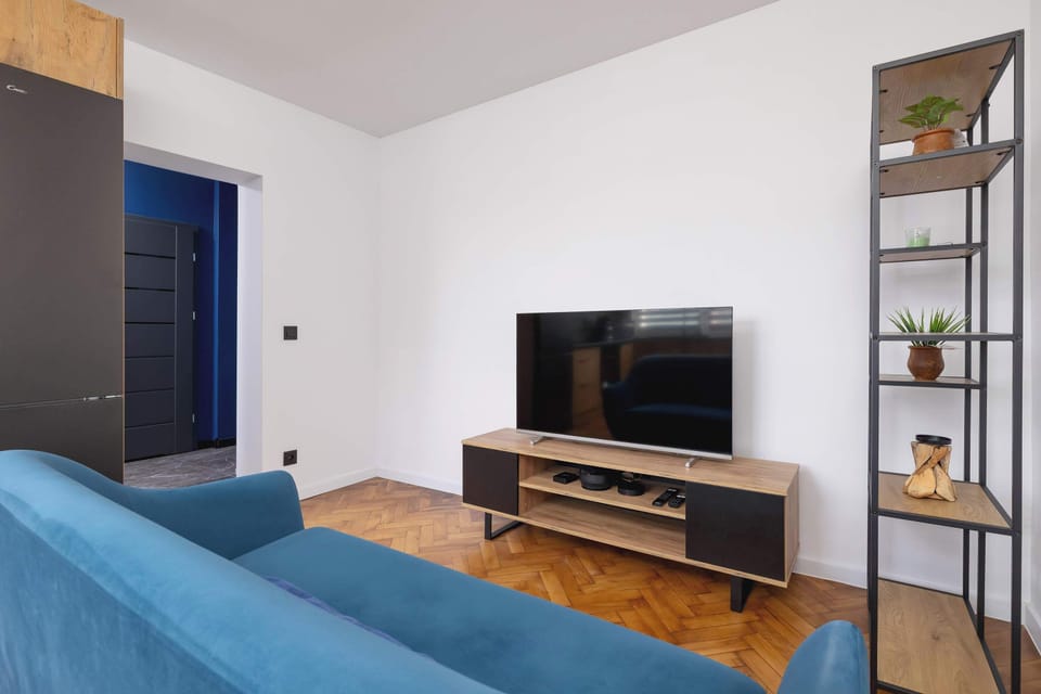 Slightly different angle showing the turquoise sofa and hallway with wooden flooring.