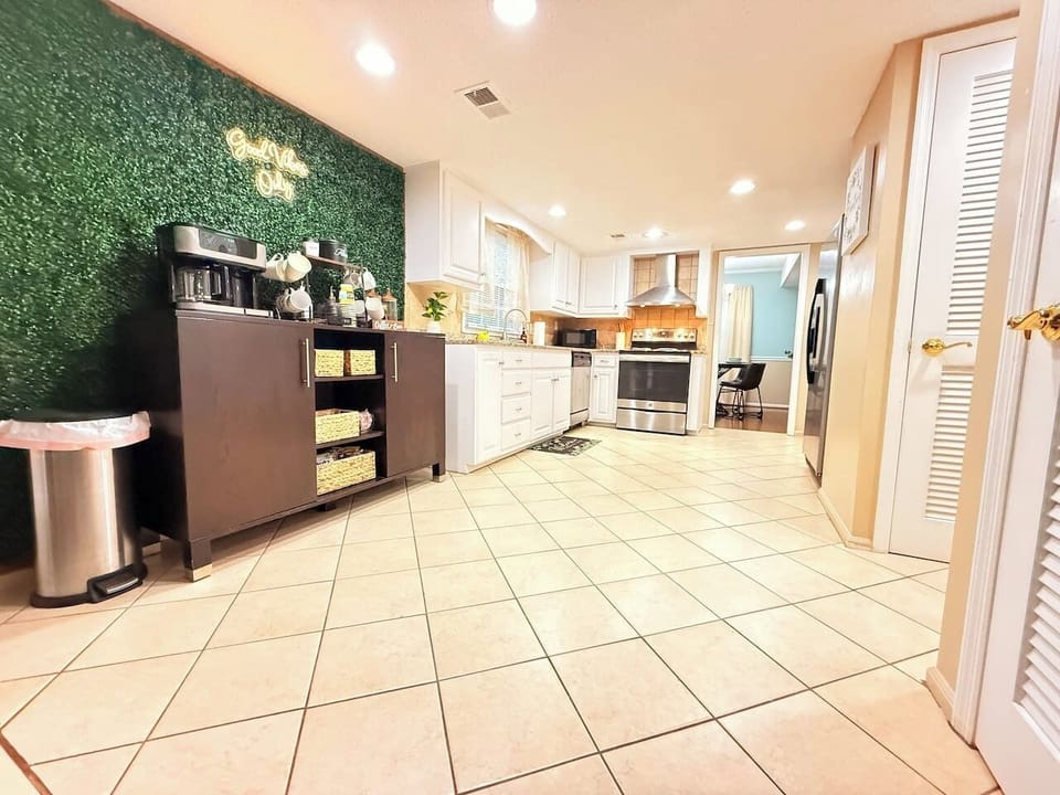 Full view of the kitchen and coffee station, showing open flow, ample lighting, and all essentials for extended stays.