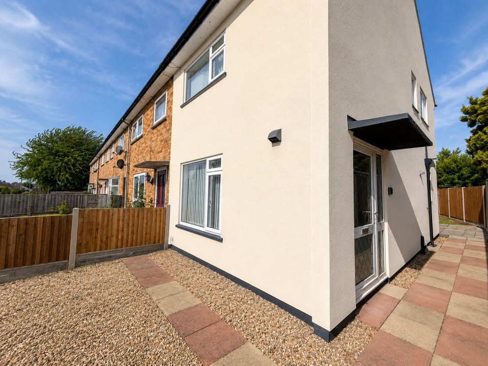 Front of property with private parking driveway 