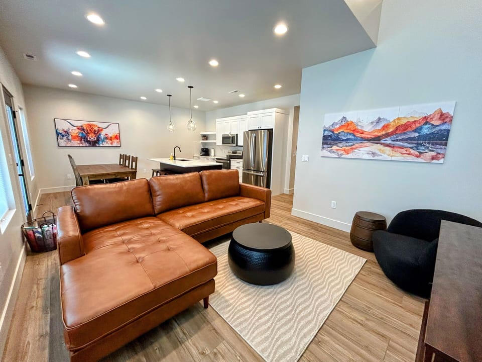 modern living room offers comfy seating, cozy fireplace, and a SmartTV