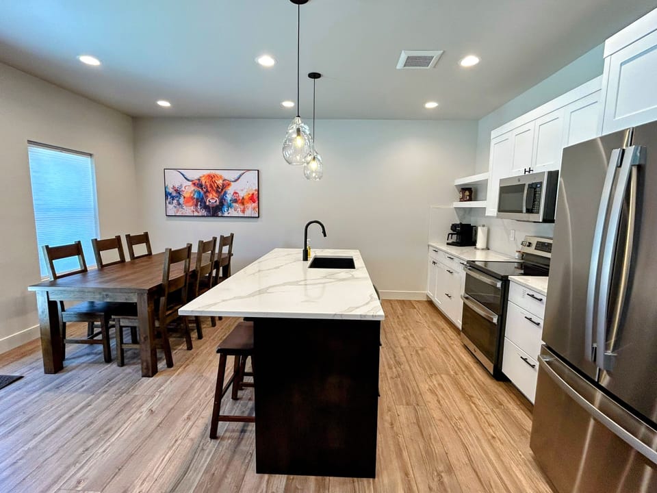 This full kitchen features everything you need, with new appliances, plenty of space, and a welcoming island at the center. It’s an easy, open area for cooking meals together before or after your daily adventures.