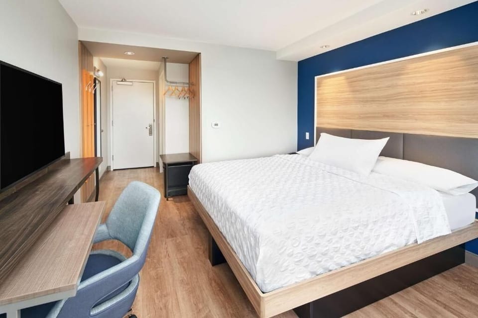 Settle into a sleek king bed after a busy day.