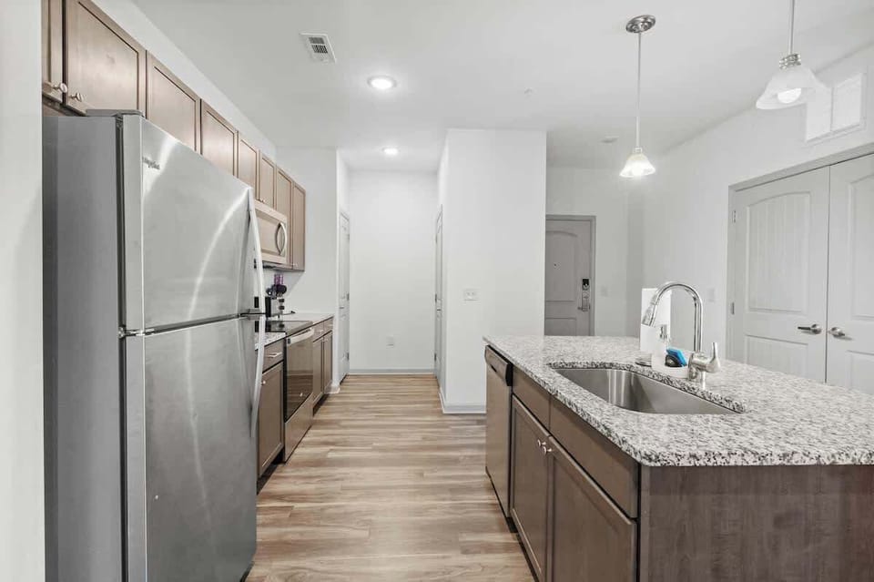Gather around the kitchen island and enjoy the vibrant energy of this space, perfect for preparing meals and making memories with family and friends.