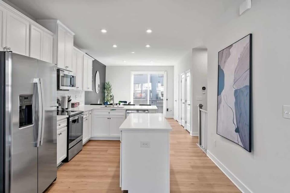 Experience the joy of cooking in this modern kitchen, where sleek countertops, state-of-the-art appliances, and plenty of storage make meal prep a breeze.