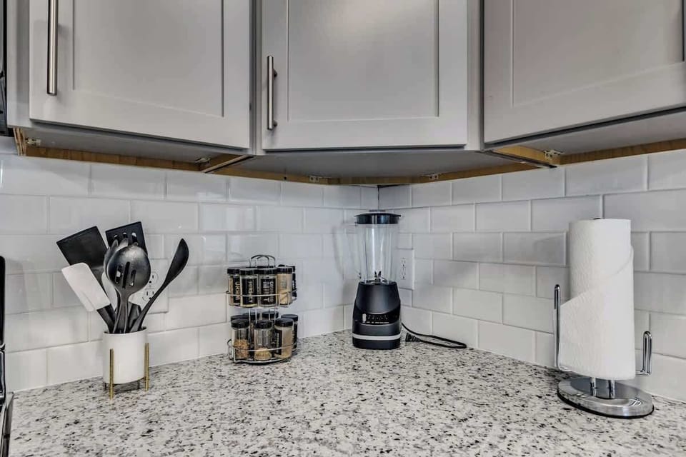 Gather around the kitchen island and enjoy the vibrant energy of this space, perfect for preparing meals and making memories with family and friends.