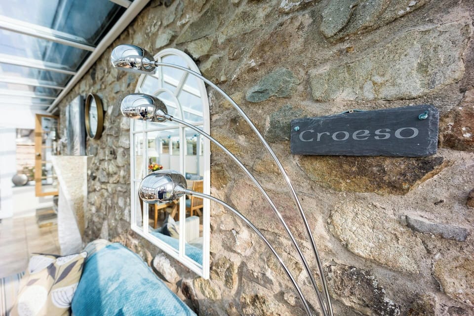 welcoming stone-plate on the wall next to a mirror in the sun room