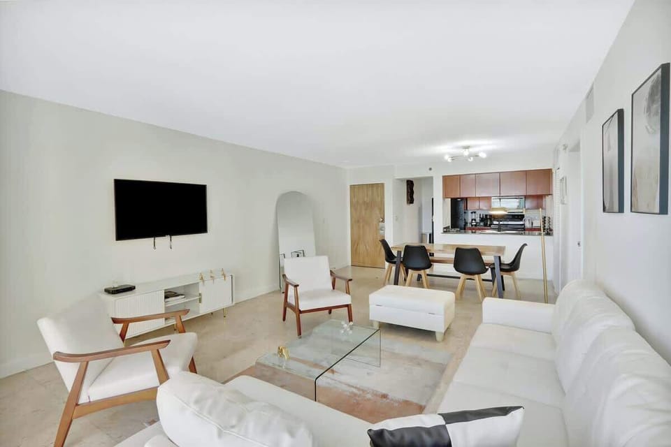 Pristine living room enriched with an abundance of natural light from floor to ceiling window!