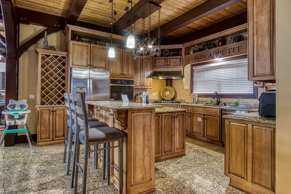 Fully equipped kitchen with granite countertops and bar seating.