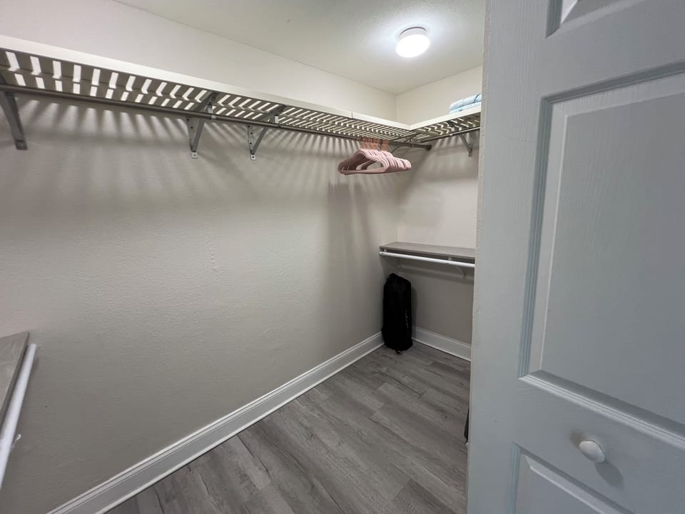 Primary bedroom walk in closet