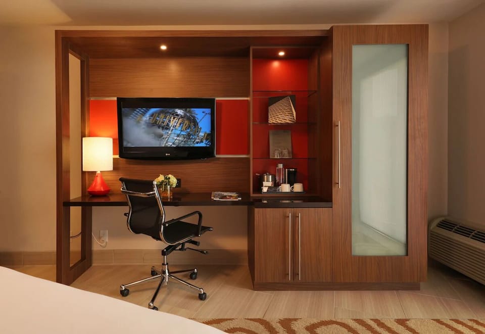 Settle in to work comfortably with desk, TV, and coffee setup
