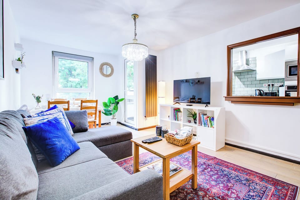 A cozy sunlit living room with comfy and stylish touches.