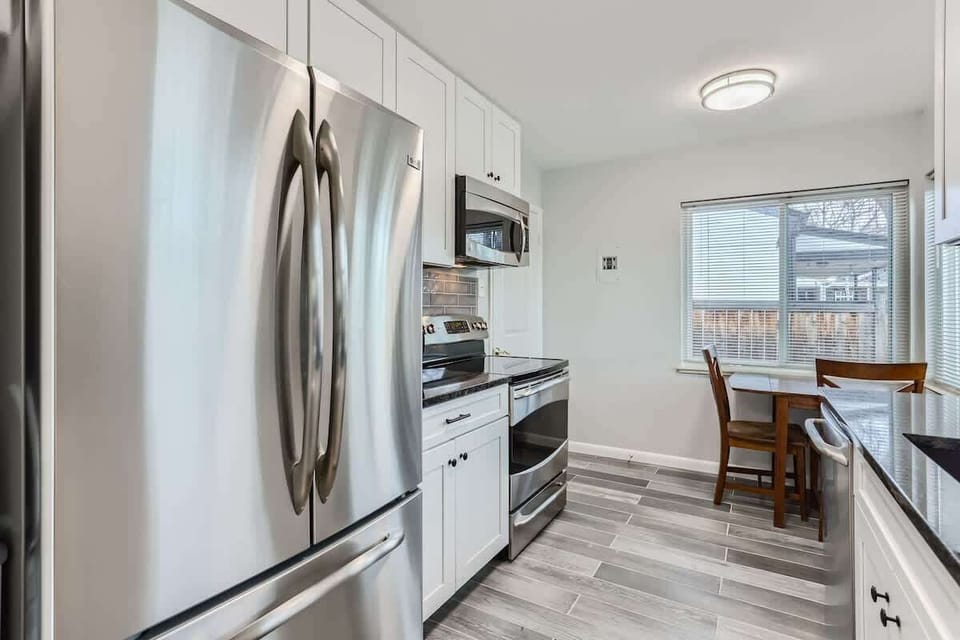 Bright, clean kitchen area with appliances and all essentials for comfortable, at-home cooking.
