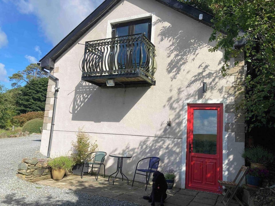 Entrance to apartment. Outdoor seating and table. 