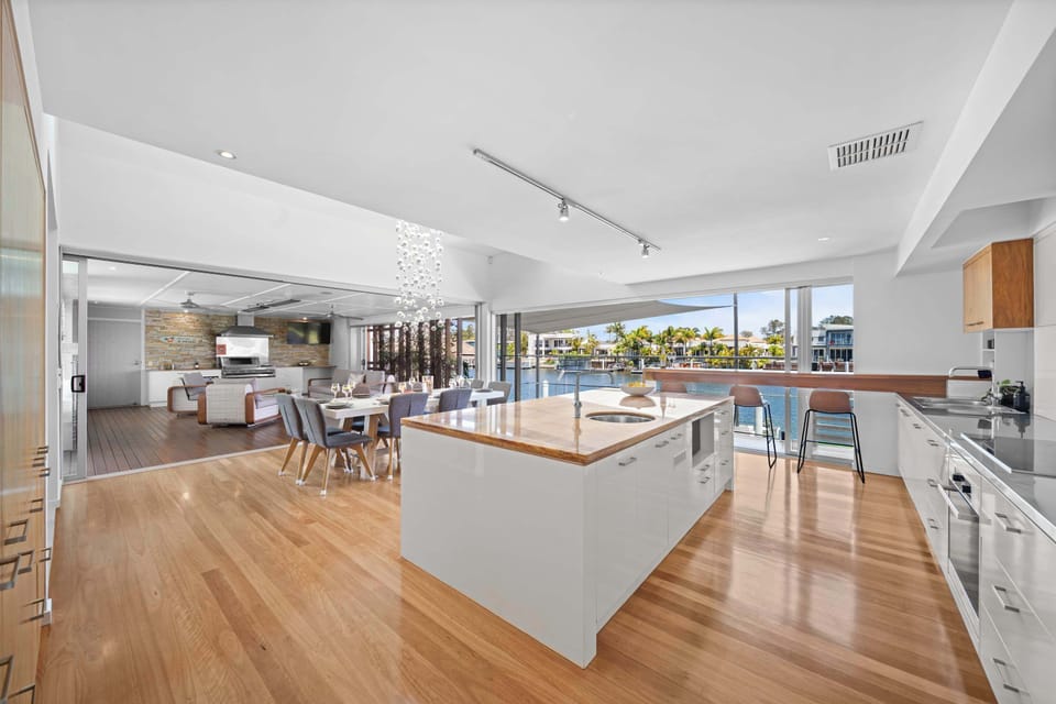 Open kitchen flowing into dining and living zones.