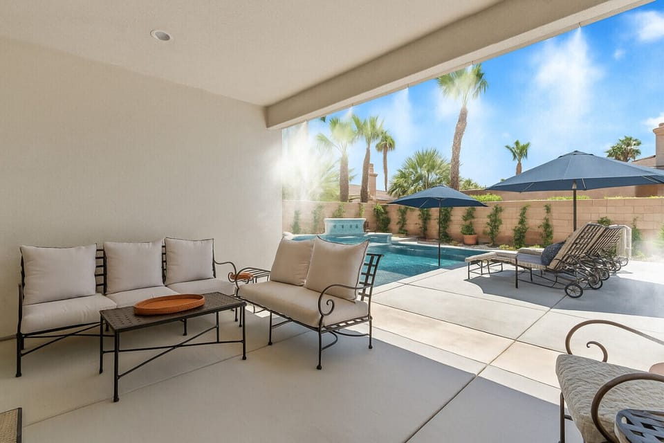 Covered patio seating w/ views of the pool, a comfortable spot to unwind outside