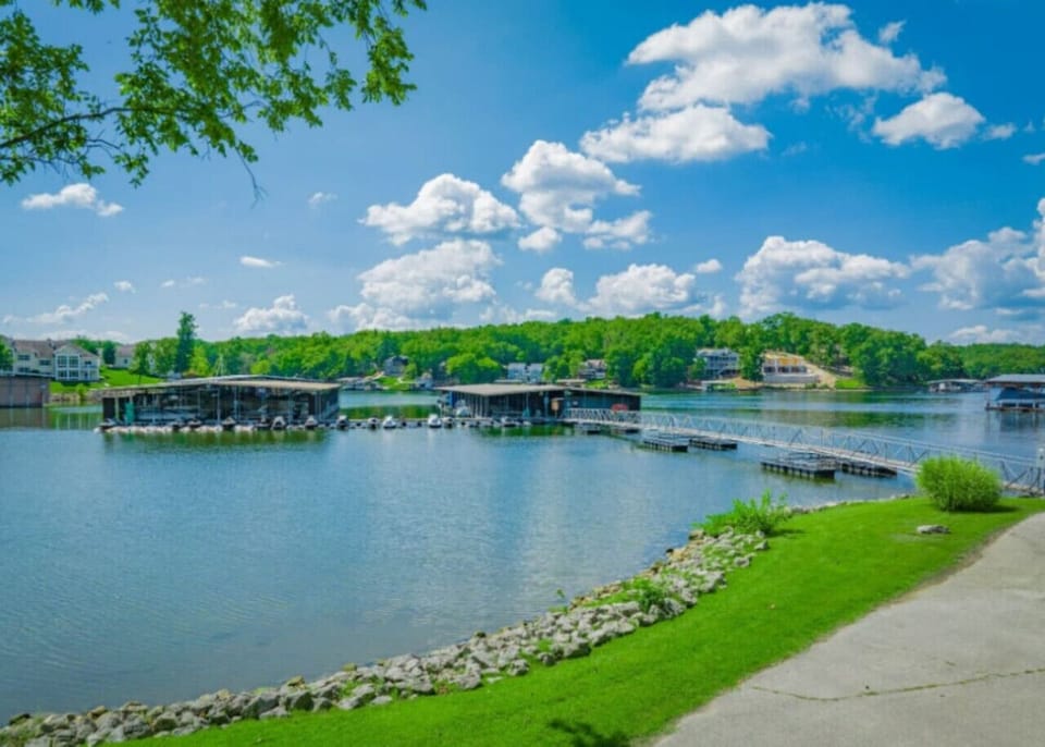 Beautiful lakefront marina community featuring covered boat slips, private dock access, calm waters, and scenic shoreline views, perfect for boating enthusiasts and waterfront living.