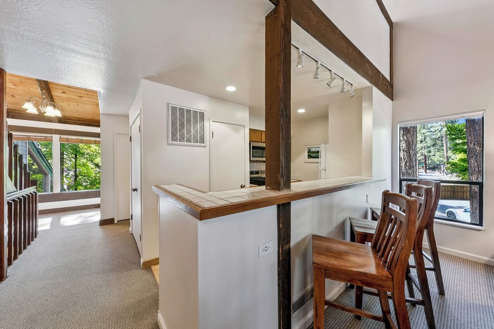 Gather around your spacious kitchen island where warm wood meets modern style, perfect for morning coffee or evening conversations.