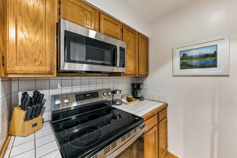 Your well-equipped kitchen offers everything you need to prepare meals, featuring stainless steel appliances and thoughtful amenities like coffee-making essentials.