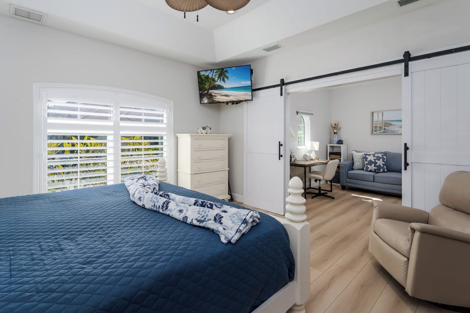 Relax in your beautifully designed suite where coastal blues meet modern comfort. You'll love the sliding barn doors that separate your sleeping and living spaces, plus your own TV for cozy nights in.
