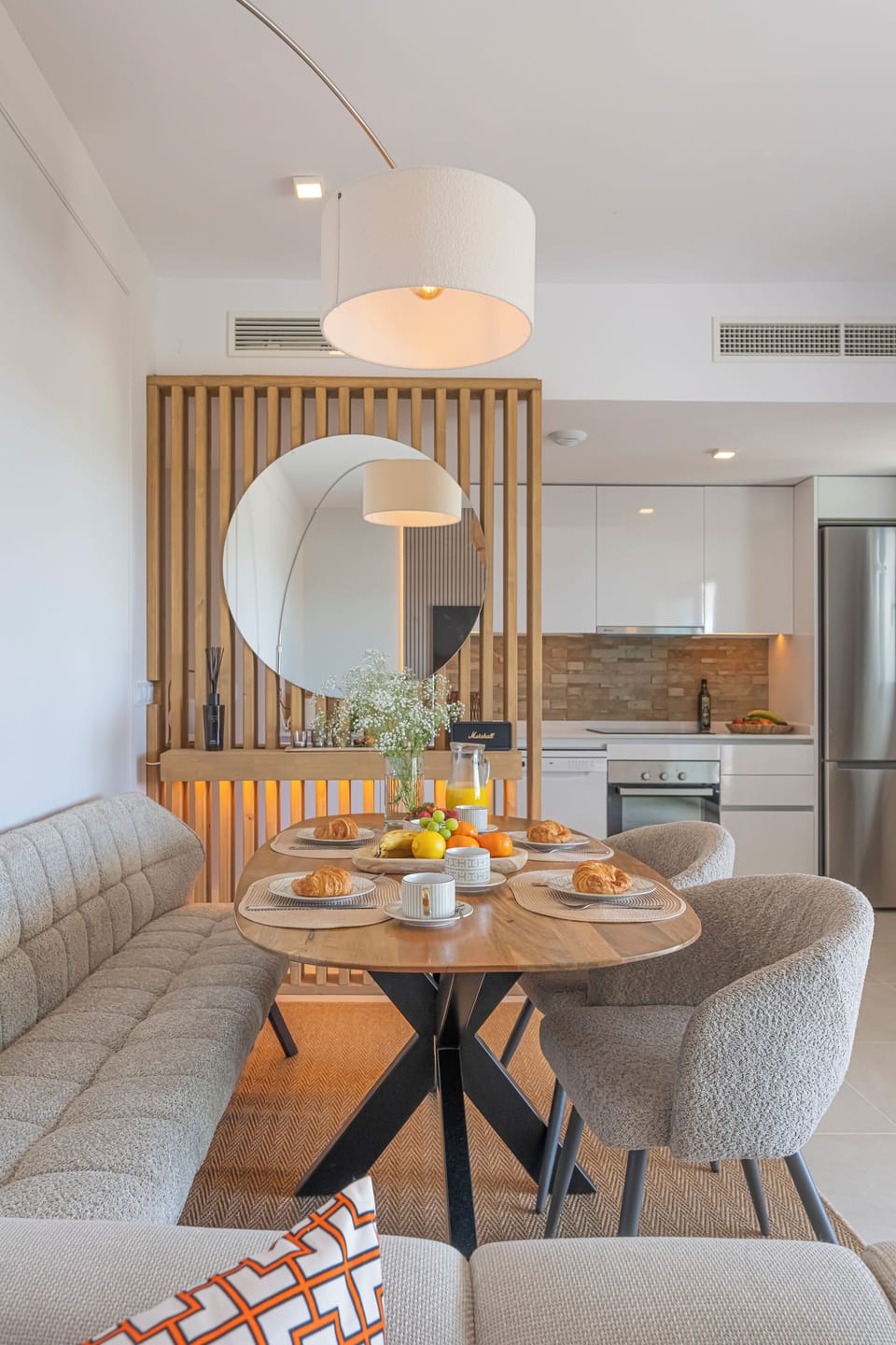 The living-dining room has a spacious sofa, table for 4, Smart TV, and balcony access. (8)