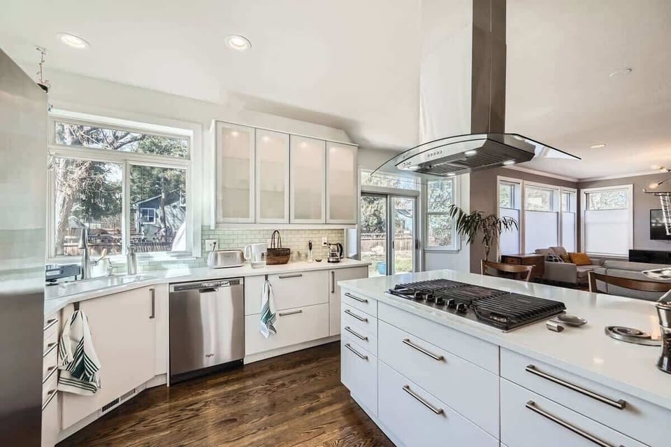 Open and well-lit kitchen with modern appliances and plenty of workspace for cooking and dining.