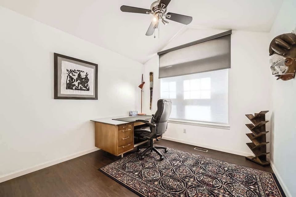 Well-lit office space with natural light, perfect for working, studying, or staying productive during your stay.