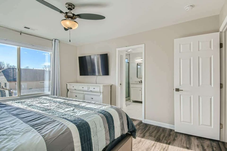 Bright Primary Bedroom Featuring a King Sized Bed 
