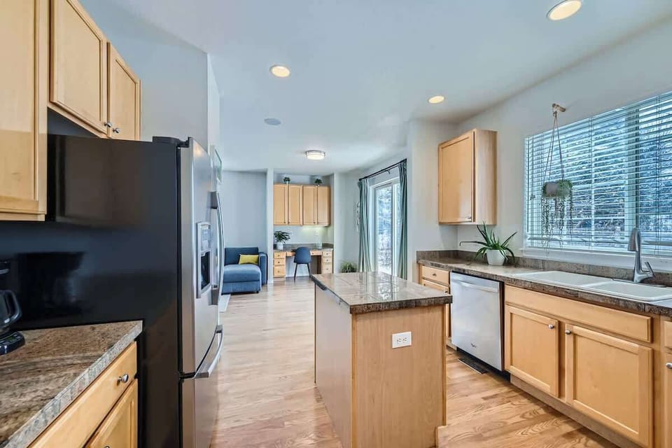 Functional kitchen area featuring a work desk, perfect for cooking, dining, or staying productive during your stay.