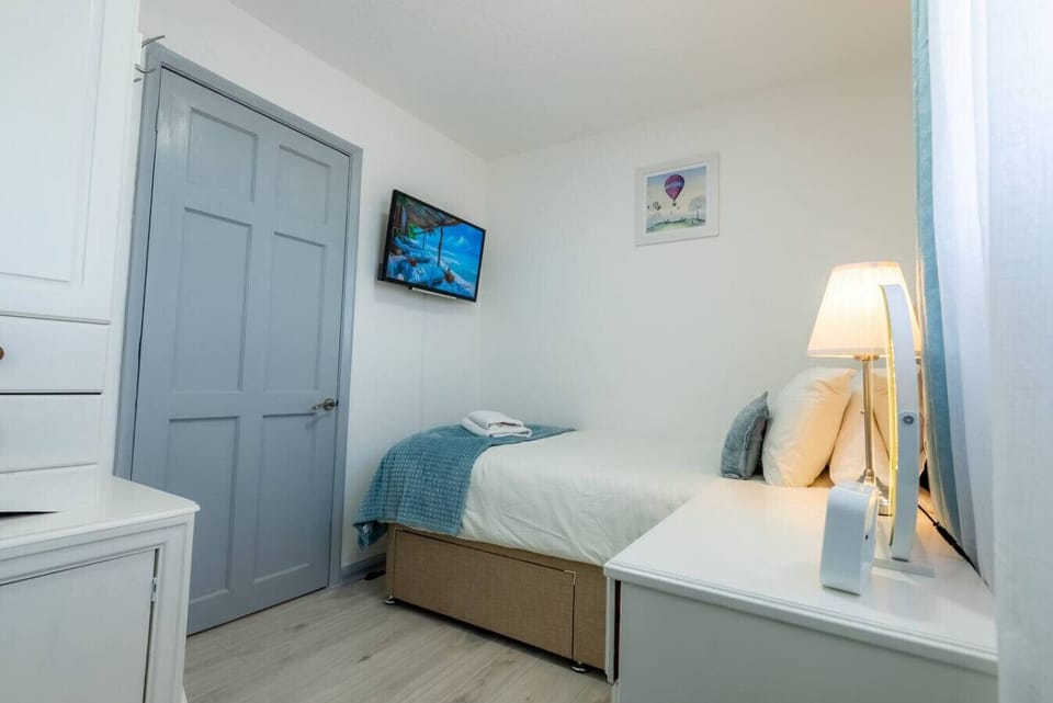 Single bedroom with wall-mounted TV for quiet downtime.