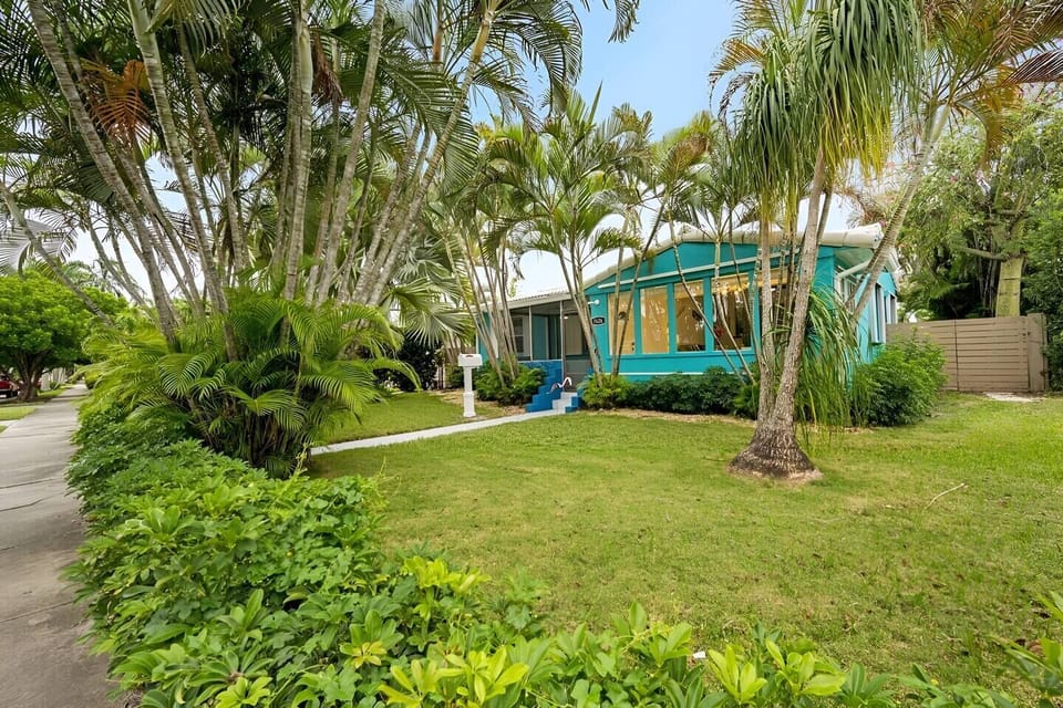 Lush garden area with pathways and vibrant greenery.
