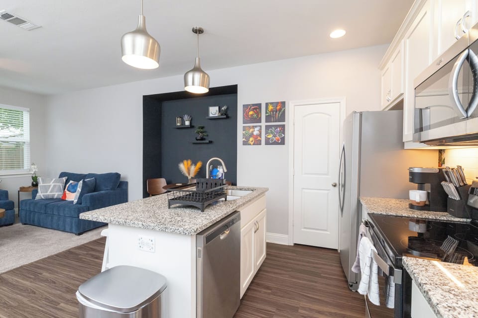 Fully stocked kitchen, island seating for 2 and stainless steel appliances.