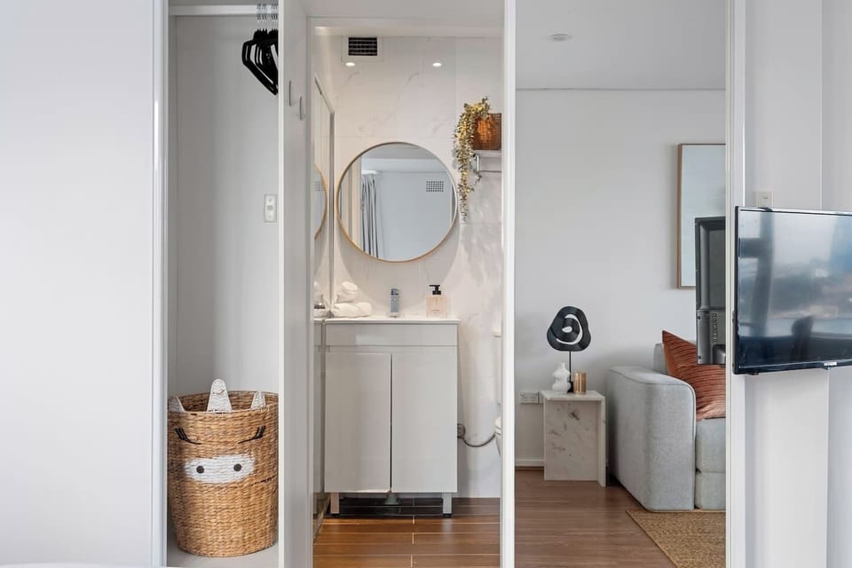 Enjoy a clever layout with the bathroom discreetly tucked behind a sliding door of cupboards, blending style with functionality.