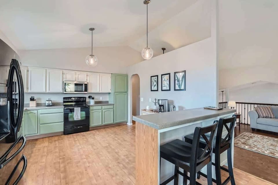 Kitchen with Two Bar Top Chairs 