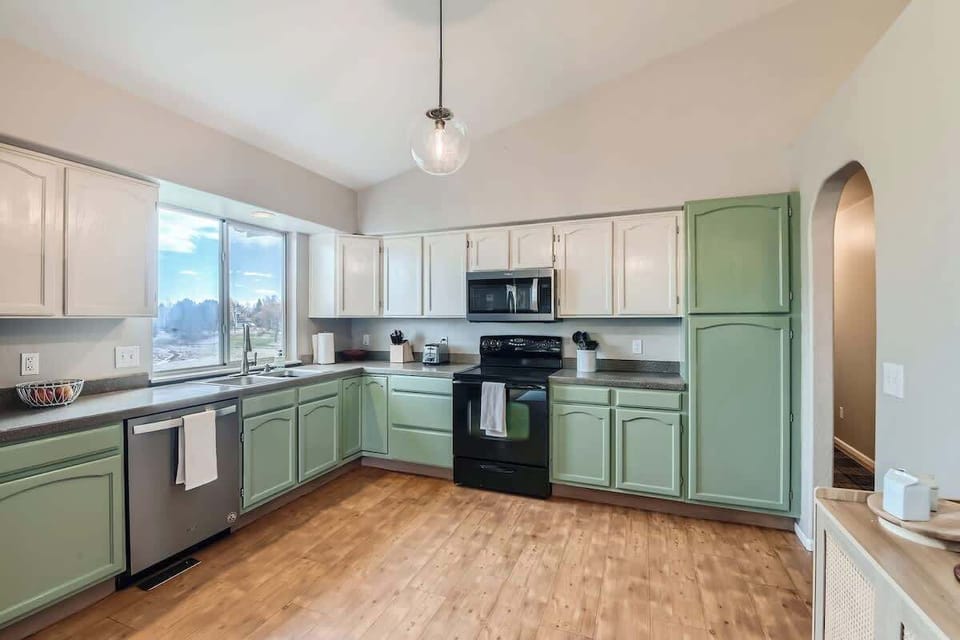 Bright and open kitchen featuring a large window that fills the space with natural light.