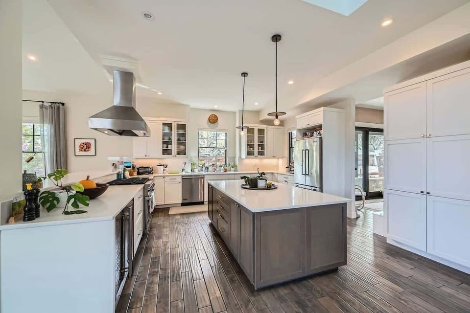 A modern, open kitchen with sleek cabinetry, stainless steel appliances, and a spacious countertop. Designed for functionality and style.