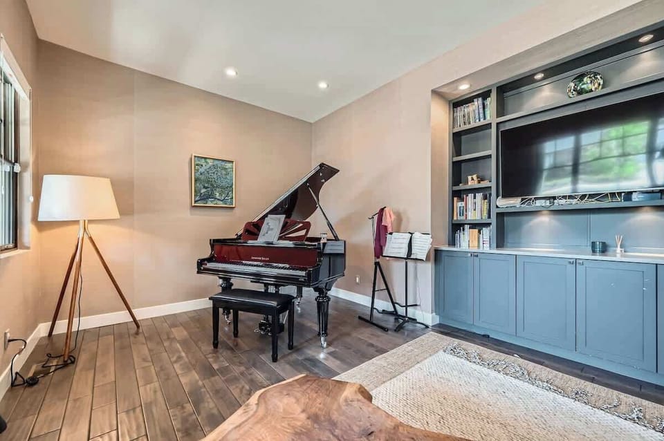 This living space features a sleek baby grand piano, blending artistry with modern design.