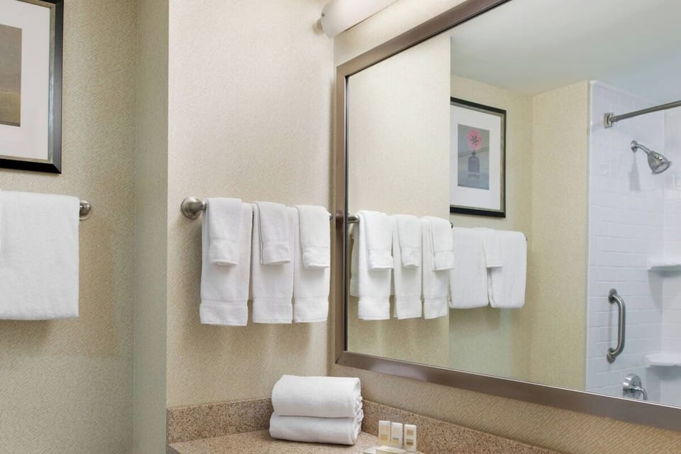 Freshen up with a spotless vanity and neatly stocked amenities.