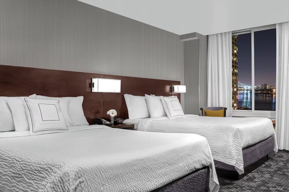Settle into crisp beds with sparkling waterfront night views.